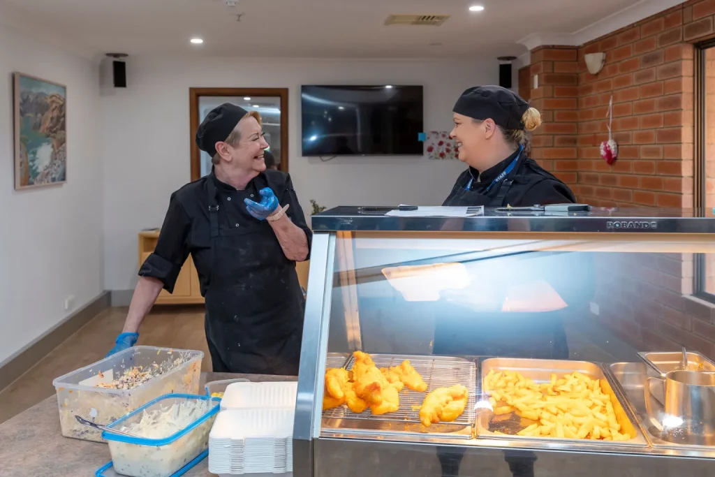 Two chefs at a buffet counter