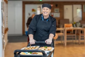 Woman pushing food trolley