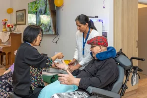 People looking after elderly person