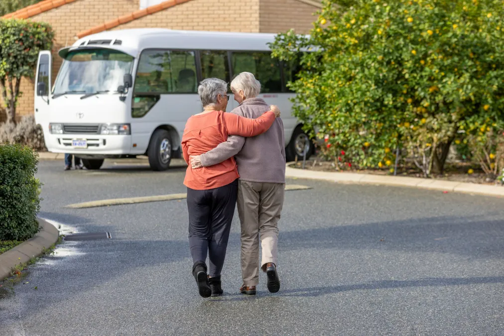 People supporting each other on way to bus