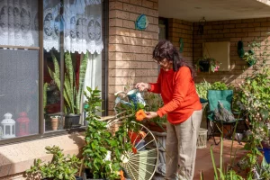 Lady watering plants in garden